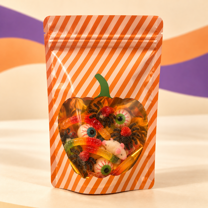 Halloween Limited Candy Community Mix: Kürbisfenster-Design – 400 g auf cremefarbenem Hintergrund mit orange-violetten Wellen